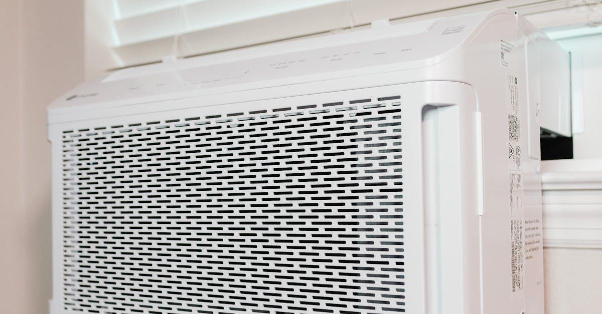 Family relaxing in Louisville home adjusting thermostat for comfort Family relaxing in Louisville home adjusting thermostat for comfort